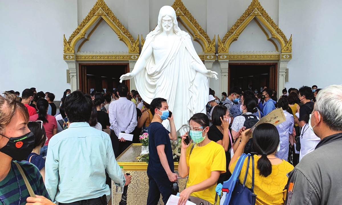 People wait to be inoculated with a dose of a COVID-19 vaccine at the Holy Redeemer catholic church in Bangkok, Thailand, on Monday. Thailand on Sunday reported 2,101 new coronavirus cases and 17 new deaths, as the country struggles with a third wave of infections. The new cases took the total number of infections to 83,375 and total fatalities to 399 since the pandemic started. Photo: AFP