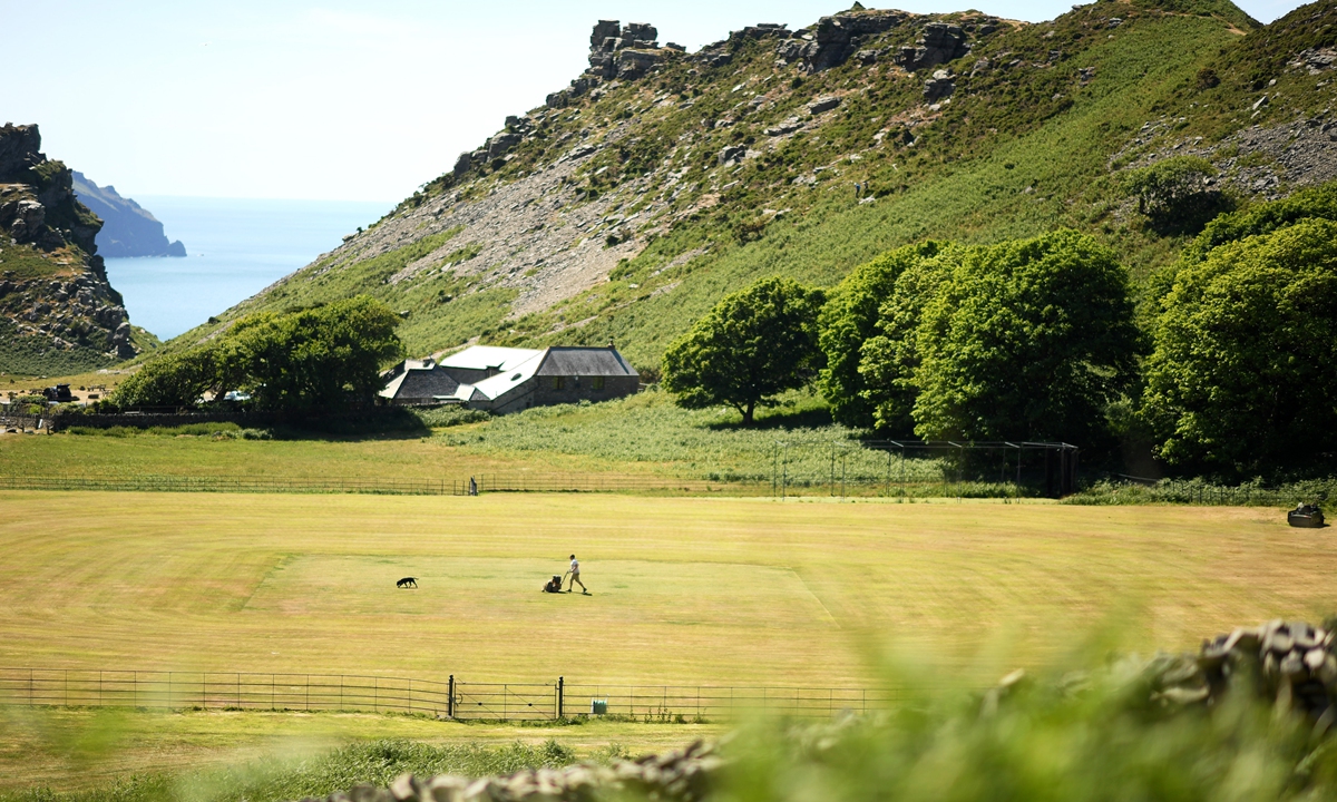 Groundsman Alex Spice works on the square at Lynton and Lynmouth Cricket Club on June 1, 2020 in Lynton, England. Photo: VCG
