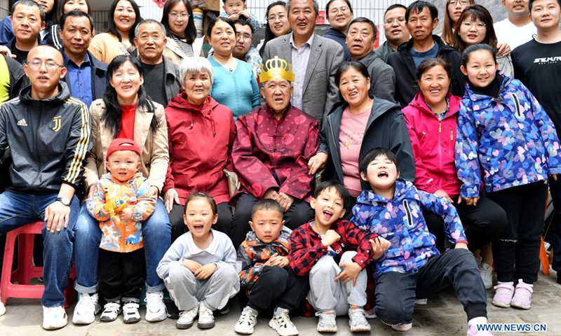 Hu Zaizhong poses for a family photo at Xuejiawan Village, Liulin County, Lyuliang City of north China's Shanxi Province on April 24, 2021. Hu Zaizhong, who has just turned 100, vividly remembers his wishes at different stages of his life: having decent food and clothing in his early days, teaching as many pupils as he could in his prime age, and enjoying quality time with his family for late years.(Photo: Xinhua)