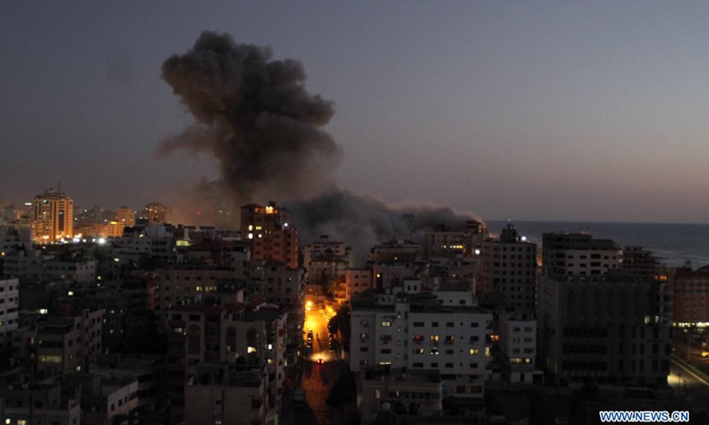 Photo taken on May 11, 2021 shows explosions following Israeli air strikes in Gaza City. Israeli military chief Aviv Kochavi decided on Tuesday to extend Israel's offensive in the Gaza Strip with no time limit amid the tensions with Hamas, a Palestinian movement that runs the strip. Three women in Israel and 28 people in Gaza Strip have been reportedly killed since Monday in the worst flare-up of Israeli-Palestinian violence since Israel's major military assault in Gaza in 2014.(Photo: Xinhua)