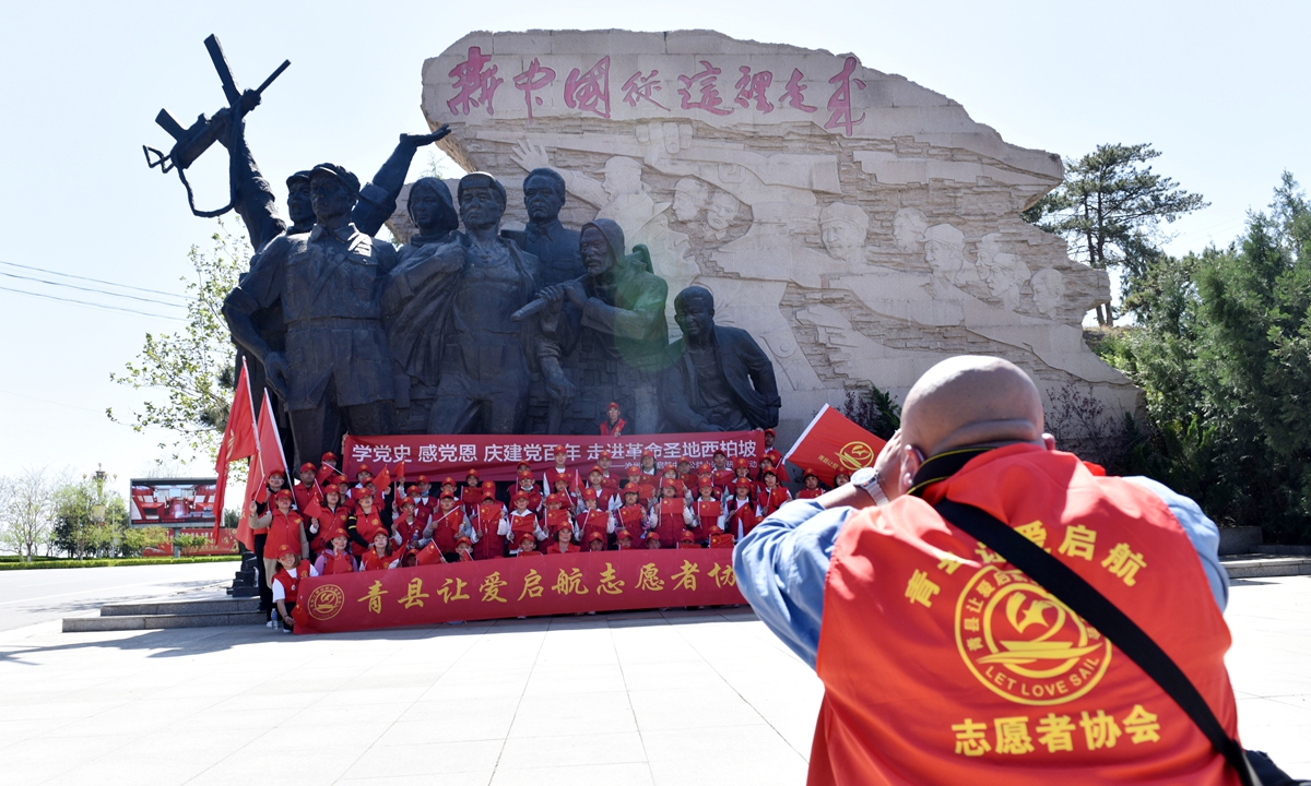 Tourists take photos in Xibaipo, Hebei Province on April 17.