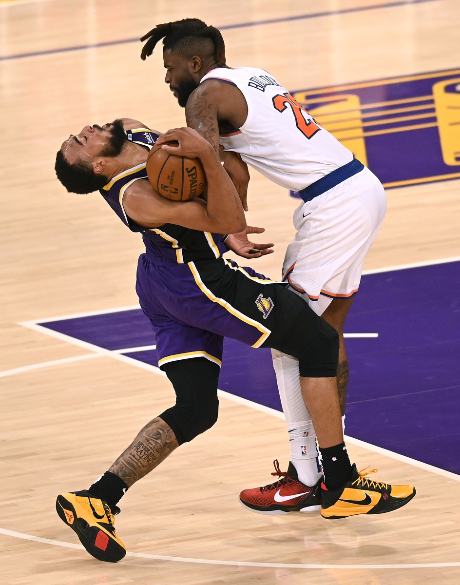 Talen Horton-Tucker (left) of the Los Angeles Lakers reacts as he is fouled by Reggie Bullock of the New York Knicks on Tuesday in Los Angeles. Photo: VCG