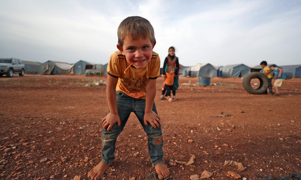 A Syrian boy poses for a picture as he plays at a camp for the internally displaced in Maaret Misrin city in Syria's northwestern Idlib province on May 8, 2021. Photo: VCG