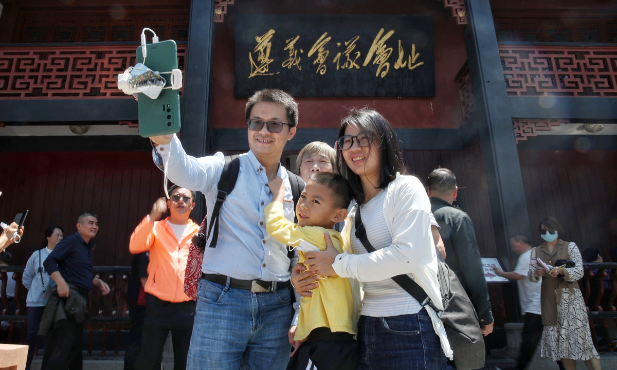 Tourists take photos in Zunyi, Guizhou Province on May 1. Photo: VCG