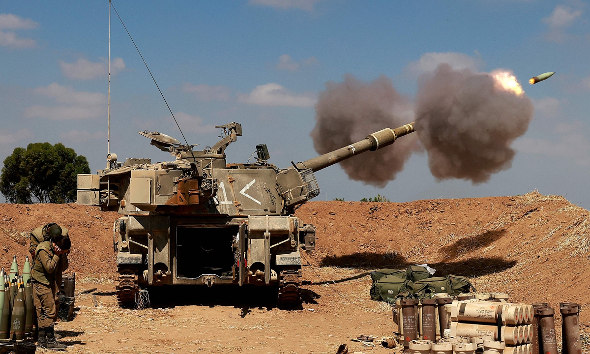 Israeli soldiers fire a 155mm self-propelled howitzer towards the Gaza Strip from their position near the southern Israeli city of Sderot on May 13, 2021. Photo: VCG