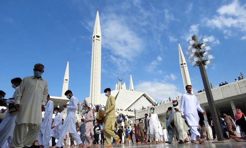 People leave after offering Eid al-Fitr prayers at the Faisal Mosque in Islamabad, capital of Pakistan on May 13, 2021. Eid al-Fitr marks the end of the Islamic holy month of Ramadan.Photo:Xinhua