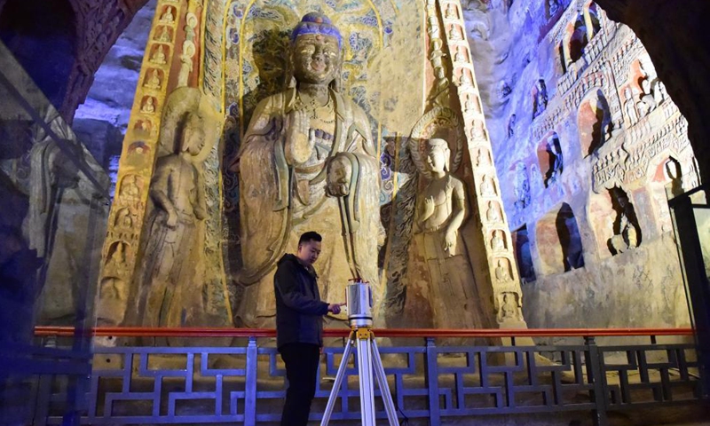 Wang Chao, a technician with the Yungang Grottoes Research Institute, collects digital image data at the Yungang Grottoes in Datong, north China's Shanxi Province, on May 8, 2021.Photo:Xinhua