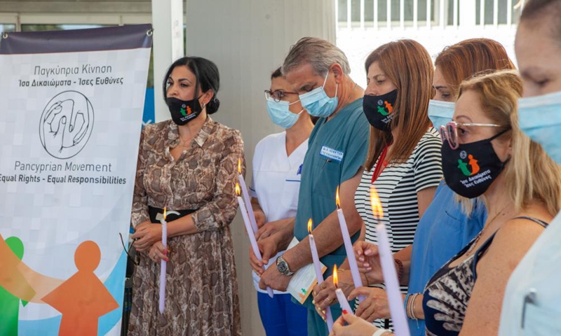 People hold candles to mourn those who died of COVID-19, at the Makario Hospital in Nicosia, Cyprus, May 14, 2021.Photo:Xinhua