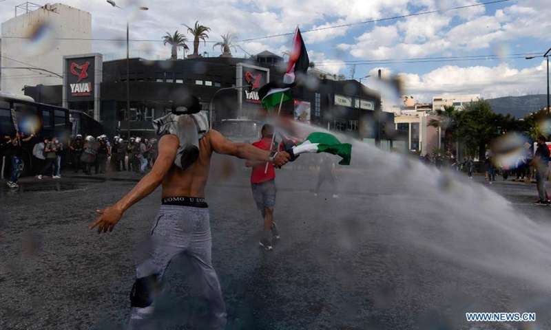 Water is thrown from water cannons to protesters, in Athens, Greece, on May 15, 2021. Hundreds of Greeks and Palestinians that live in Greece protested on Saturday outside the Israel's embassy in Athens against Israeli attacks on Gaza. (Photo: Xinhua)