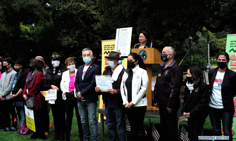 Participants display signs at a rally against racism and hate crimes in San Mateo, California, the United States, May 15, 2021. A few hundred people including government officials and local residents from several cities in San Mateo participated in the rally on Saturday, calling for all cities and communities to unite and to stop racism and hate crimes. Photo: Xinhua
