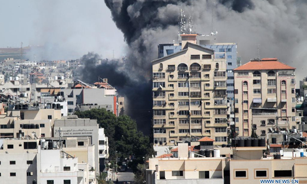 Smoke billows following an Israeli airstrike on Jala Tower, which housed offices of Al-Jazeera TV and Associated Press as well as residential apartments, in Gaza City, on May 15. Israel said Saturday it struck the high-rise building in Gaza City housing offices of international media outlets because it contained assets of Hamas intelligence agency. Photo: Xinhua


