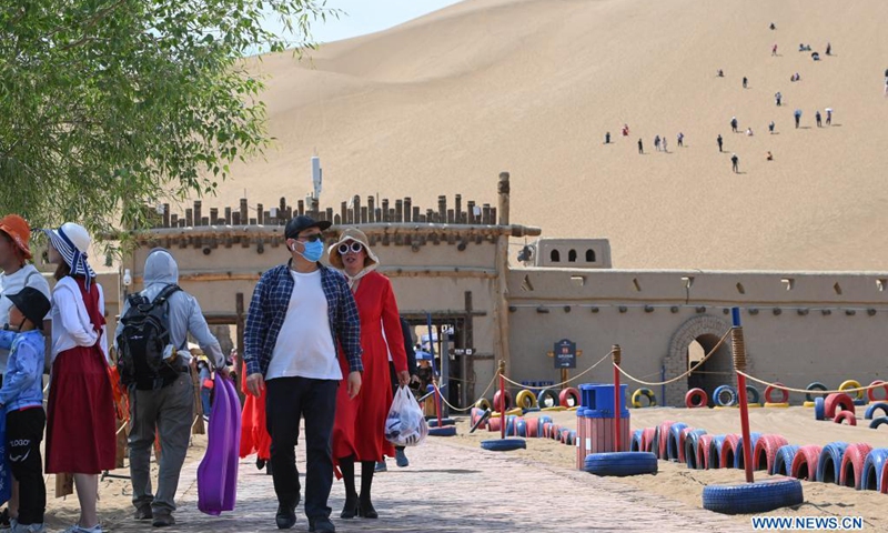 People visit Kumtag Desert in Shanshan County, northwest China's Xinjiang Uygur Autonomous Region, May 16, 2021. The county sees boom in desert tourism early May.(Photo: Xinhua)