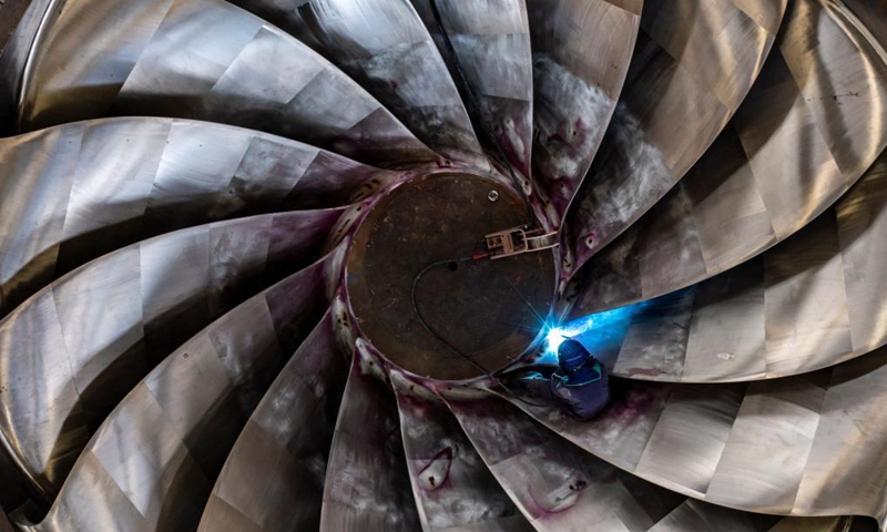A man works at the construction site of the Baihetan hydropower station in southwest China, May 13, 2021. Baihetan on the Jinsha River, the upper section of the Yangtze, straddles the southwest provinces of Yunnan and Sichuan. With a total installed capacity of 16 million kilowatts, it is the second-largest hydropower station in China in terms of installed capacity, second only to the Three Gorges Dam project in the central province of Hubei.(Photo: Xinhua)