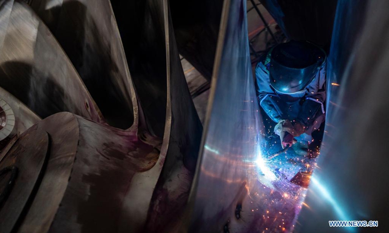 A man works at the construction site of the Baihetan hydropower station in southwest China, May 14, 2021. Baihetan on the Jinsha River, the upper section of the Yangtze, straddles the southwest provinces of Yunnan and Sichuan. With a total installed capacity of 16 million kilowatts, it is the second-largest hydropower station in China in terms of installed capacity, second only to the Three Gorges Dam project in the central province of Hubei.(Photo: Xinhua)
