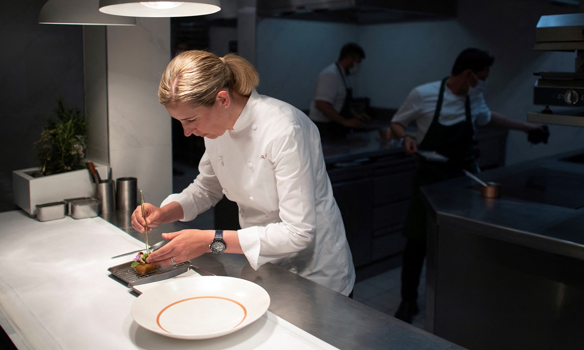 Britain's newest winner of three Michelin stars, Clare Smyth poses for a photo at her restaurant 
in west London on Thursday. Photos: AFP