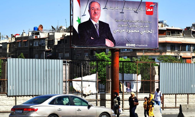 A poster of a Syrian presidential candidate is seen in Damascus, Syria, May 16, 2021. The Syrian presidential campaigns have officially started on Sunday as posters of President Bashar al-Assad and the two other candidates filled the squares and streets in the capital Damascus.(Photo:Xinhua)