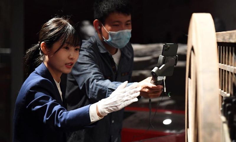 Zeng Hongjuan (L) introduces car collections to the audience via livestreaming at Beijing Auto Museum in Beijing, capital of China, April 30, 2020. Zeng Hongjuan, who was born in the 1990s, is a tour guide at the Beijing Auto Museum. Since taking this job, Zeng has been always thinking about how to introduce automobile knowledge and development history to the audience in plain language.(Photo: Xinhua)