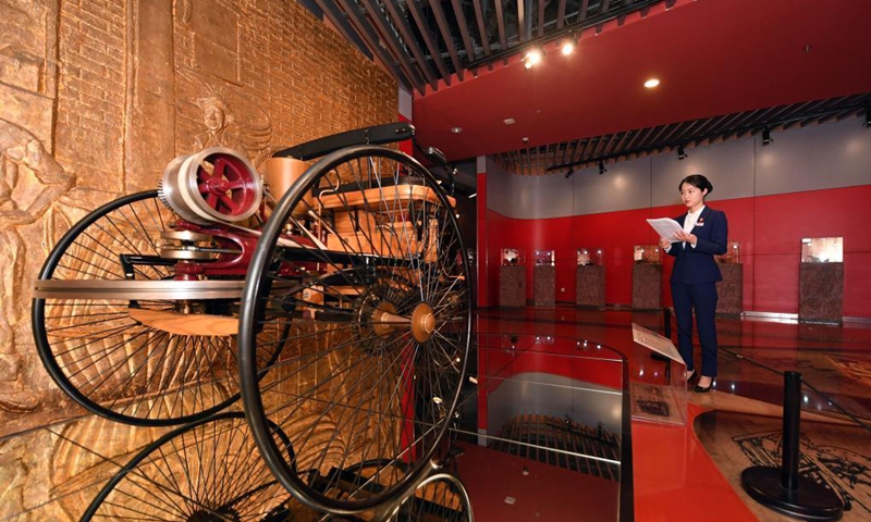 Zeng Hongjuan reviews knowledge about cars at Beijing Auto Museum in Beijing, capital of China, May 14, 2021. Zeng Hongjuan, who was born in the 1990s, is a tour guide at the Beijing Auto Museum.(Photo: Xinhua)