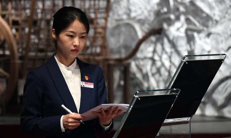 Zeng Hongjuan reviews knowledge about cars at Beijing Auto Museum in Beijing, capital of China, May 14, 2021. Zeng Hongjuan, who was born in the 1990s, is a tour guide at the Beijing Auto Museum. Since taking this job, Zeng has been always thinking about how to introduce automobile knowledge and development history to the audience in plain language.(Photo: Xinhua)
