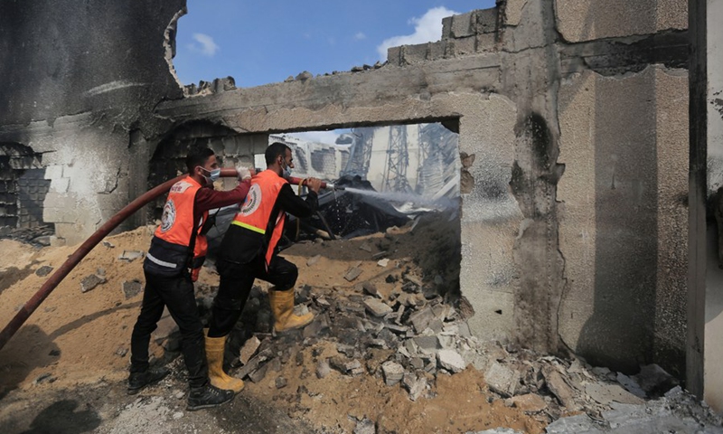 Palestinian firefighters extinguish a fire after an Israeli airstrike in Gaza City, on May 17, 2021.(Photo: Xinhua)
