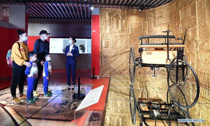 Zeng Hongjuan (1st R) introduces car collections to visitors at Beijing Auto Museum in Beijing, capital of China, May 16, 2021. Zeng Hongjuan, who was born in the 1990s, is a tour guide at the Beijing Auto Museum. Since taking this job, Zeng has been always thinking about how to introduce automobile knowledge and development history to the audience in plain language.(Photo: Xinhua)