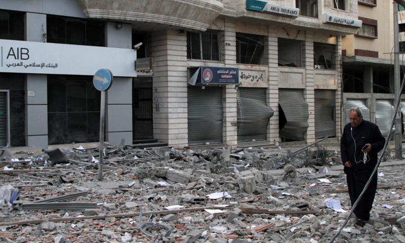 A Palestinian man inspects a damaged building after an Israeli air strike in Gaza City, on May 17, 2021. The intense fighting between Israel and Gaza's ruler Hamas killed 204 Palestinians, including 59 children, and 10 Israelis, including a five-year-old boy and a soldier.(Photo: Xinhua)