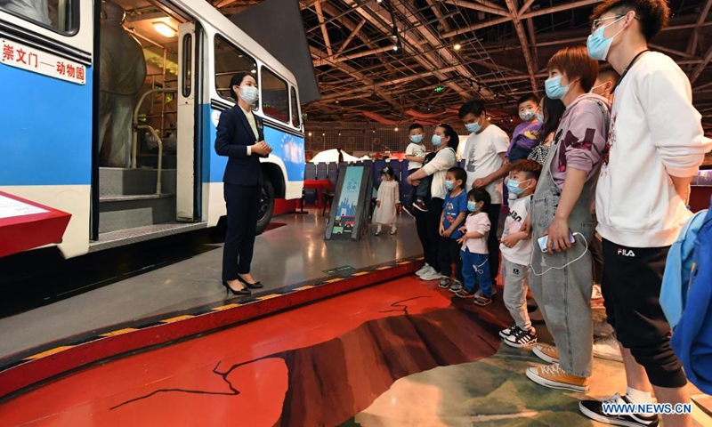 Zeng Hongjuan (1st L) introduces car collections to visitors at Beijing Auto Museum in Beijing, capital of China, May 16, 2021. Zeng Hongjuan, who was born in the 1990s, is a tour guide at the Beijing Auto Museum.(Photo: Xinhua)