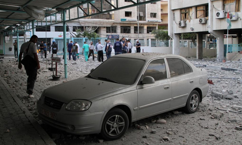 People gather at a damaged building after an Israeli air strike in Gaza City, on May 17, 2021. The intense fighting between Israel and Gaza's ruler Hamas killed 204 Palestinians, including 59 children, and 10 Israelis, including a five-year-old boy and a soldier.(Photo: Xinhua)