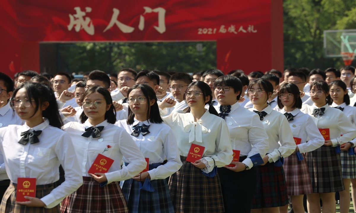 Students at Beijing Guangqumen High School attend their Coming of Age ceremony on Tuesday. In front of their parents and teachers, they put on 