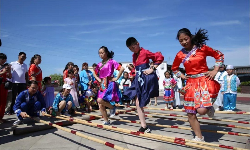 Children take part in a bamboo dance at the New Residents Festival held in August 2020 in Fuxi subdistrict of Deqing in East China's Zhejiang Province. Photo: Courtesy of Fuxi subdistrict