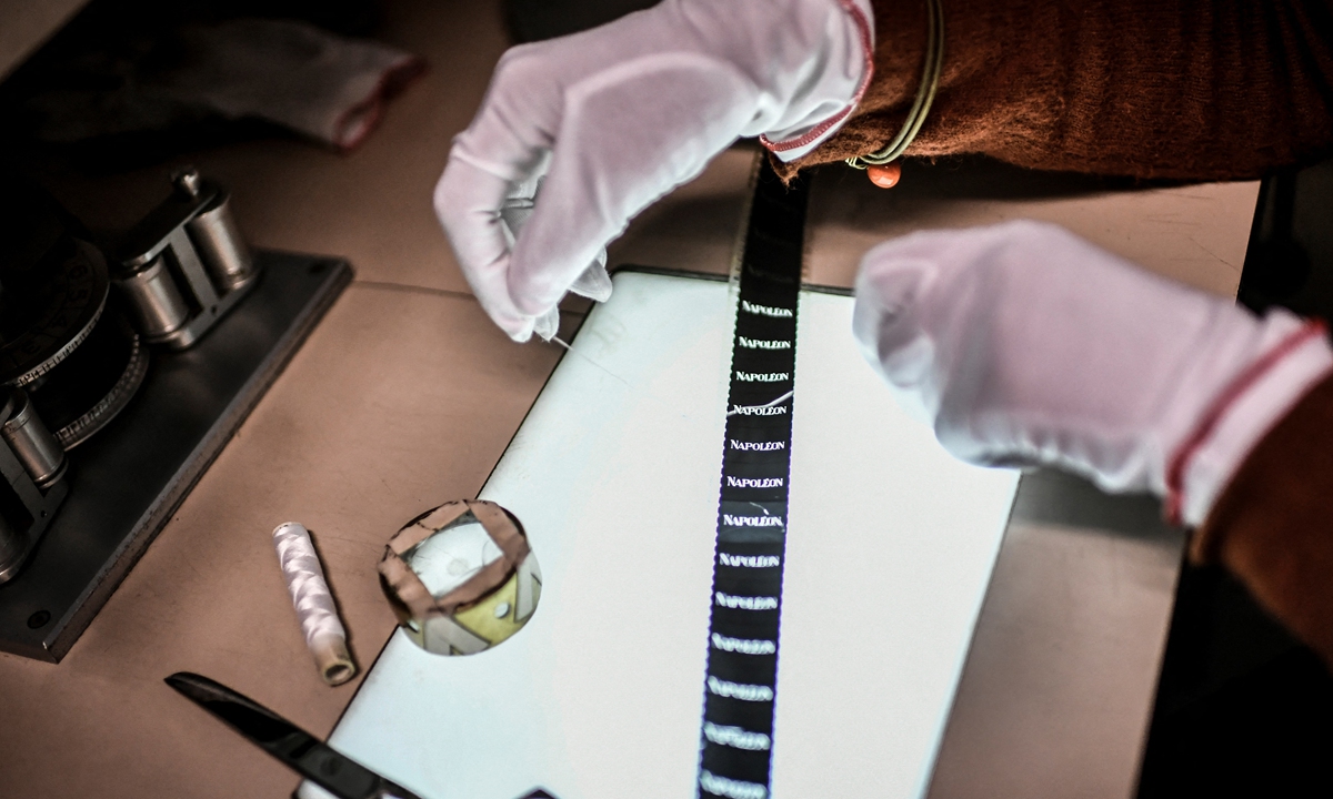 A film editor works on the reconstruction of the Apollo version of the movie <em>Napoleon</em> (1927) by French director Abel Gance in the buildings of the Cinematheque Francaise at the Fort-de-Saint-Cyr in Montigny-le-Bretonneux, near Paris, on May 6. Photo: AFP