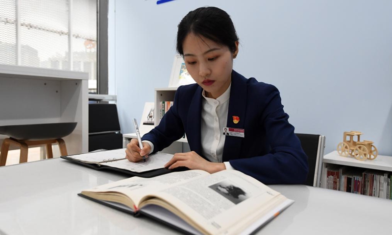 Zeng Hongjuan learns knowledge about new energy cars at Beijing Auto Museum in Beijing, capital of China, May 14, 2021. Zeng Hongjuan, who was born in the 1990s, is a tour guide at the Beijing Auto Museum.(Photo: Xinhua)