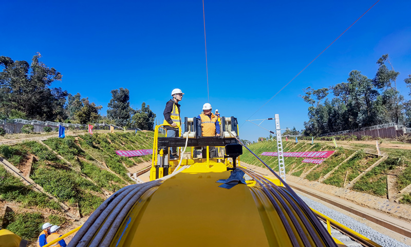 Workers place the first electricity catenary on the China-Laos Railway in Southwest China's Yunnan Province on November 19, 2020. Photo: VCG
