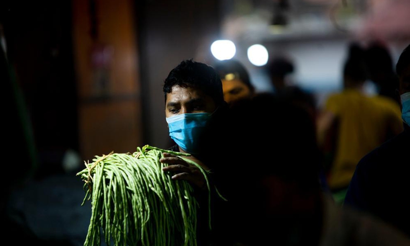 A man wearing a face mask is seen at a local market in Kathmandu, Nepal, May 19, 2021.(Photo: Xinhua)