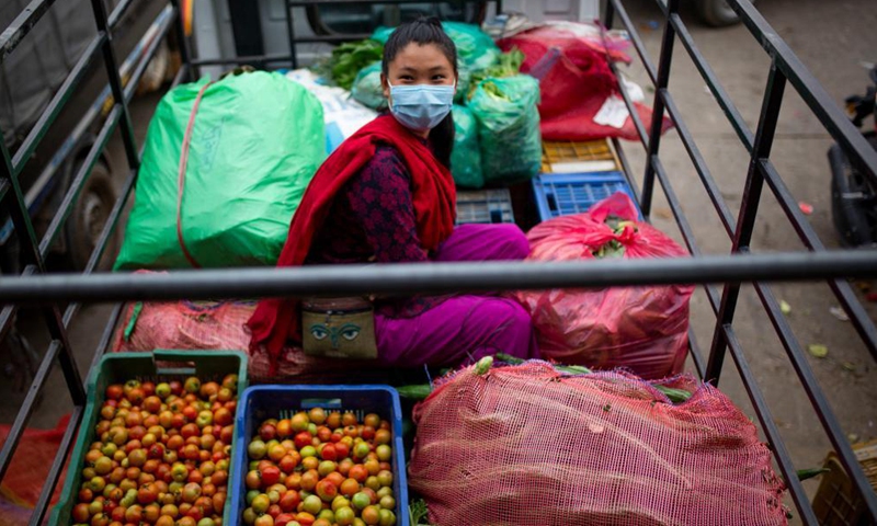 A woman wearing a face mask is seen at a local market in Kathmandu, Nepal, May 18, 2021.(Photo: Xinhua)