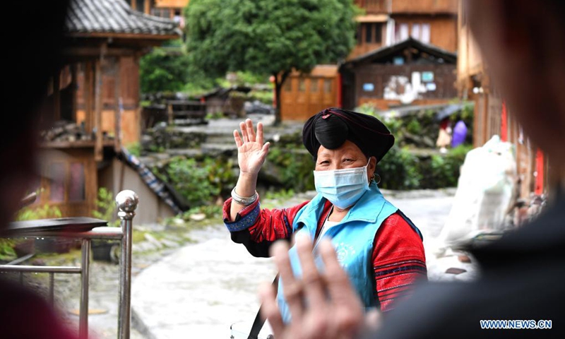 Pan Jiping waves goodbye after visiting patients at Xiaozhai Village of Longji Township, Longsheng County, south China's Guangxi Zhuang Autonomous Region, May 18, 2021.(Photo: Xinhua)