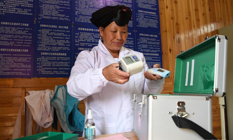 Pan Jiping prepares her emergency kit for home visits at Xiaozhai Village of Longji Township, Longsheng County, south China's Guangxi Zhuang Autonomous Region, May 18, 2021. In Xiaozhai, a village at the foot of Fupingbao Mountain over 1,900 meters above sea level, Pan Jiping has been a country doctor here for more than 30 years.(Photo: Xinhua)
