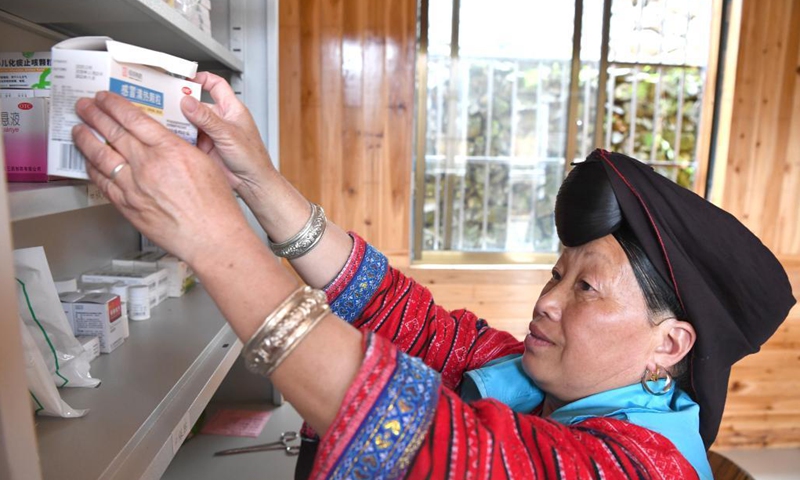 Pan Jiping arranges medicine at Xiaozhai Village of Longji Township, Longsheng County, south China's Guangxi Zhuang Autonomous Region, May 18, 2021.(Photo: Xinhua)