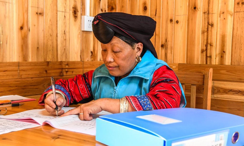 Pan Jiping fills in health records at Xiaozhai Village of Longji Township, Longsheng County, south China's Guangxi Zhuang Autonomous Region, May 18, 2021.(Photo: Xinhua)