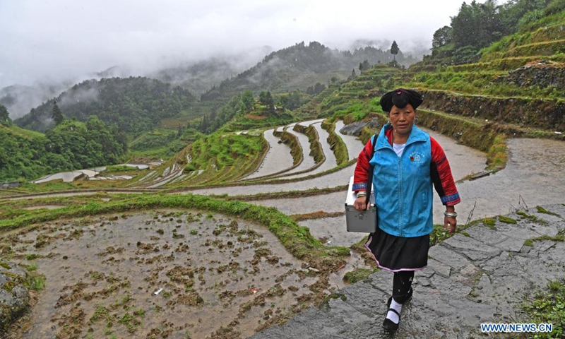 Pan Jiping is on her way to visit patients at Xiaozhai Village of Longji Township, Longsheng County, south China's Guangxi Zhuang Autonomous Region, May 18, 2021.(Photo: Xinhua)