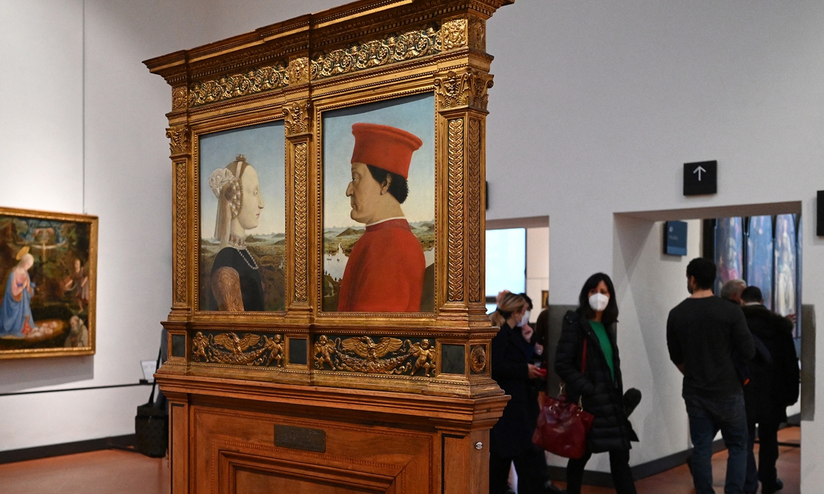 Visitors view Piero della Francesca's 1472-75 Portraits of the Duke and Duchess of Urbino on January 21 at the reopening of the Uffizi Galleries in Florence, Tuscany.  Photo: AFP