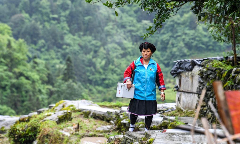 Pan Jiping is on her way to visit patients at Xiaozhai Village of Longji Township, Longsheng County, south China's Guangxi Zhuang Autonomous Region, May 18, 2021.(Photo: Xinhua)