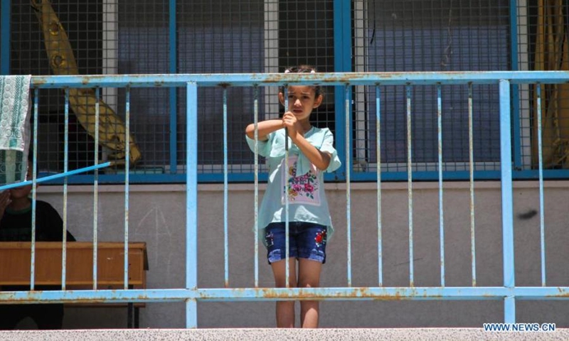 Palestinian girl Lamis Al-Sultan poses for a photo at a school in Gaza City, on May 19, 2021. Al-Sultan, 7 years old, who fled her home after it was damaged during Israeli air strikes, takes refuge at the school as many other Palestinians.(Photo: Xinhua)