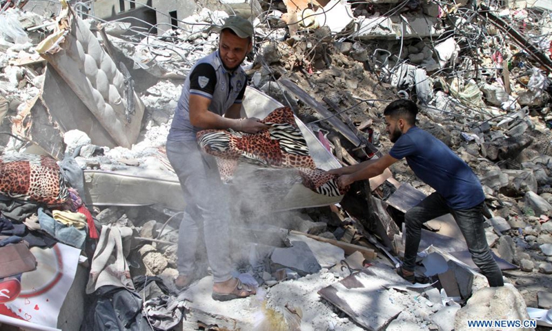 Palestinians inspect a destroyed house after an Israeli air strike in Gaza City, on May 19, 2021.(Photo: Xinhua)
