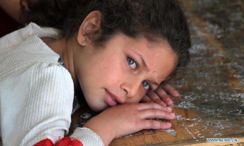 Palestinian girl Basma Abu Rasas poses for a photo at a school in Gaza City, on May 19, 2021. Abu Rasas, 7 years old, who fled her home after it was damaged during Israeli air strikes, takes refuge at the school as many other Palestinians.(Photo: Xinhua)