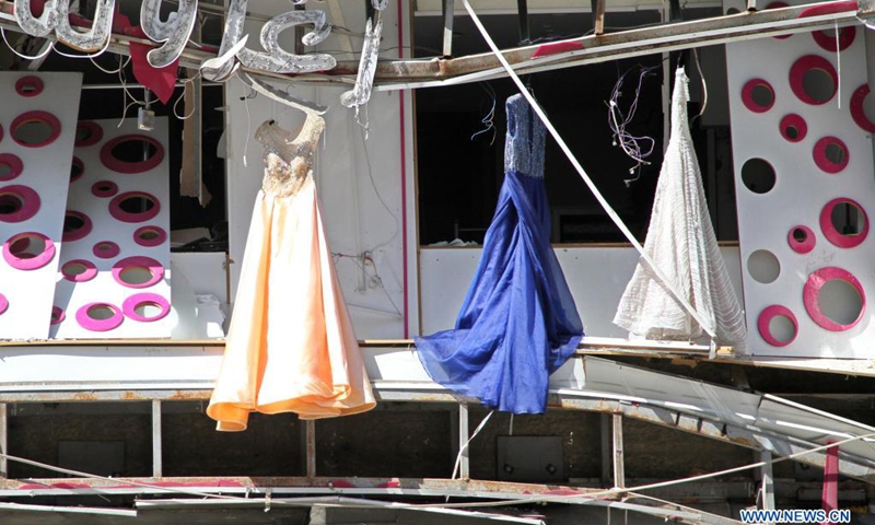 Clothes are seen from a damaged store among the rubble of a destroyed tower after an Israeli air strike in Gaza City, on May 19, 2021.(Photo: Xinhua)
