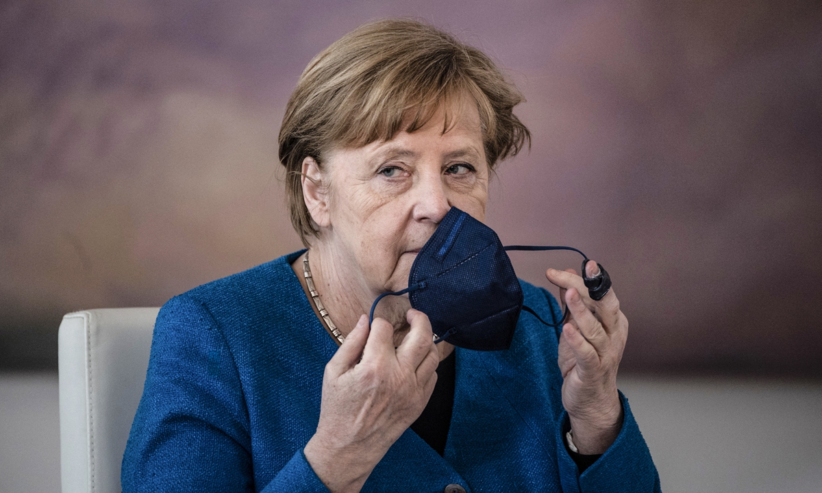 German Chancellor Angela Merkel takes off her face mask as she attends an official dismissal and appointment ceremony at the Bellevue presidential palace in Berlin on Thursday, a day after German politician Franziska Giffey resigned from her post as Minister for Family Affairs, Senior Citizens, Women and Youth over claims she plagiarized her doctoral thesis. Photo: AFP
