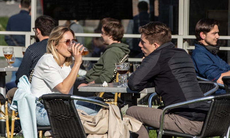 People are seen at a terrace of a bar in Lille, northern France, May 19, 2021. France on Wednesday took an important step forward towards returning to normality as people in the country can once again meet up in cafes or enjoy a meal in restaurants, which are now allowed to open their terraces.(Photo:Xinhua)