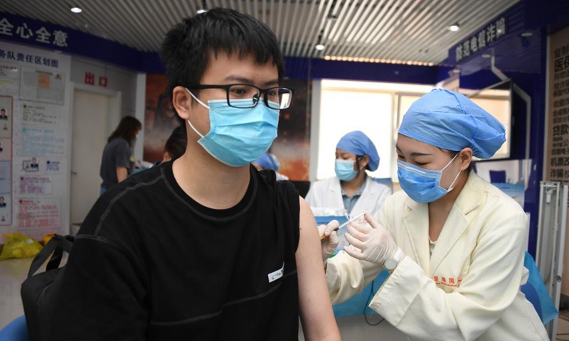 A medical worker administers a dose of the recombinant COVID-19 vaccine (adenovirus type 5 vector) which requires only one shot to a resident at a temporary vaccination site in Haidian District of Beijing, capital of China, May 20, 2021.Photo:Xinhua