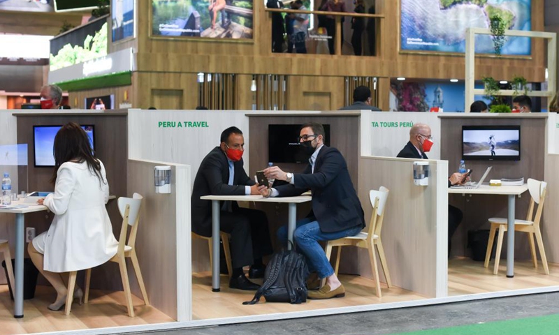 An exhibitor talks with a visitor during the 2021 Madrid Tourism Expo in Madrid, Spain, May 20, 2021. The 2021 Madrid Tourism Expo is held here from May 19 to 23.Photo:Xinhua